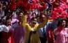 People wave plastic flowers during a military parade marking the 70th anniversary of North Korea's foundation in Pyongyang