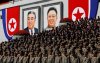 Military officers stand near portraits of North Korea founder Kim Il Sung (L) and late leader Kim Jong Il during a military parade marking the 70th anniversary of North Korea's foundation in Pyongyang