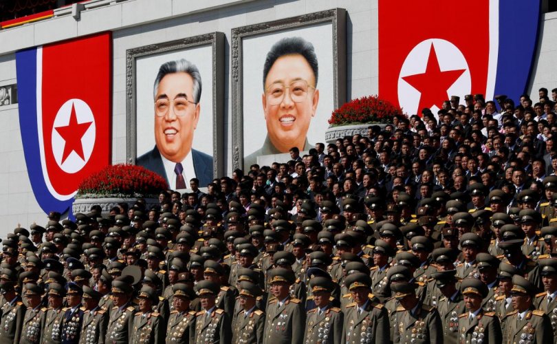 Military officers stand near portraits of North Korea founder Kim Il Sung (L) and late leader Kim Jong Il during a military parade marking the 70th anniversary of North Korea's foundation in Pyongyang