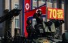 A soldier salutes as he rides a tank during a military parade marking the 70th anniversary of North Korea's foundation in Pyongyang