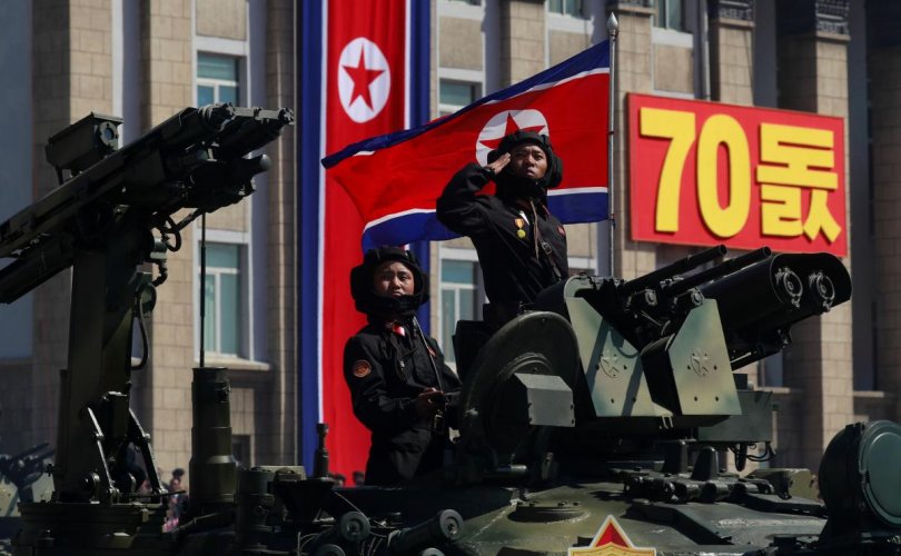 A soldier salutes as he rides a tank during a military parade marking the 70th anniversary of North Korea's foundation in Pyongyang