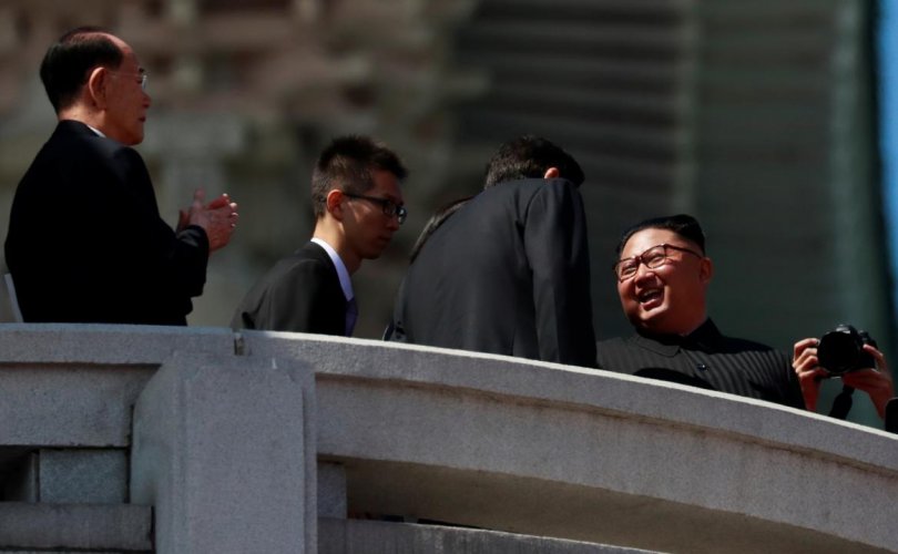 North Korean leader Kim Jong Un speaks to China's Li Zhanshu, chairman of the Standing Committee of the National People's Congress (NPC),  during a military parade marking the 70th anniversary of North Korea's foundation in Pyongyang