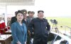 North Korean leader Kim stands next to his wife as they attend the 2014 Combat Flight Contest among commanding officers of the Korean People's Air Force